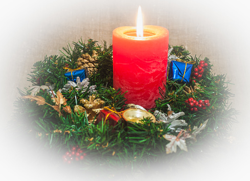 Christmas wreath with burning candle