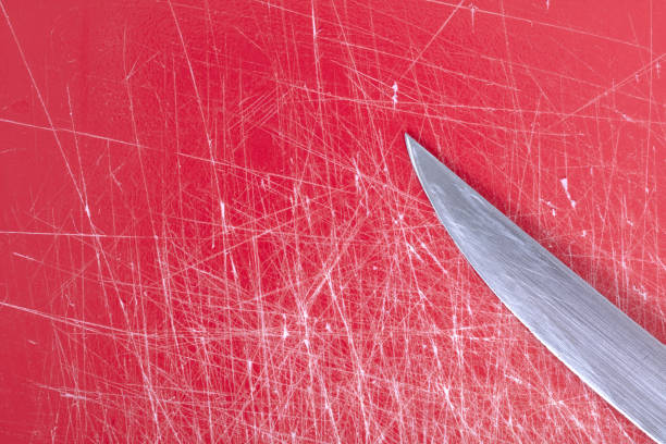 Color gradient red old plastic cutting board background with scratches, full frame