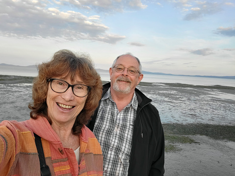 Wife takes a happy selfie of her and her husband at Yanakie Beach near Duck's Point on Wilsons Promontory. The area is a Marine Reserve and has pristine beaches and walking trails.
