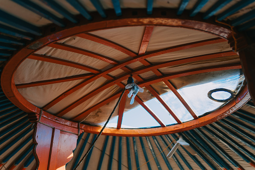Inside a real Mongolian tent. Traditional mongolian yurt interior. Mongolia decorating ceiling with decor furnishing objects equipment style elements house domestic