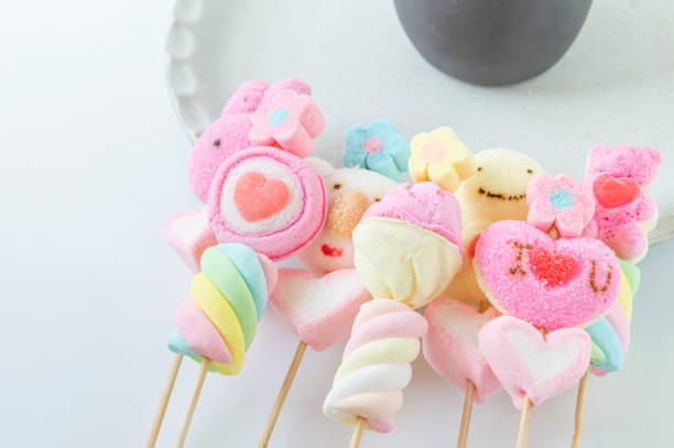 Cartoon marshmallow, colorful, sweet flavor on white background.
