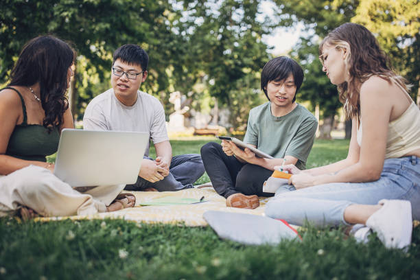 istock Friends sitting in park 1737212961