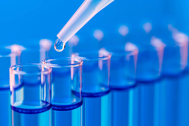 Close-up of test tubes being filled with liquid stock photo