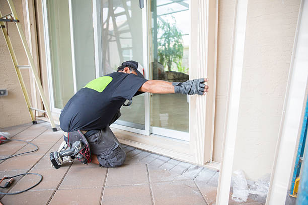 Installing Hurricane Shutters Contractor installing hurricane shutters.  rr patio doors stock pictures, royalty-free photos & images