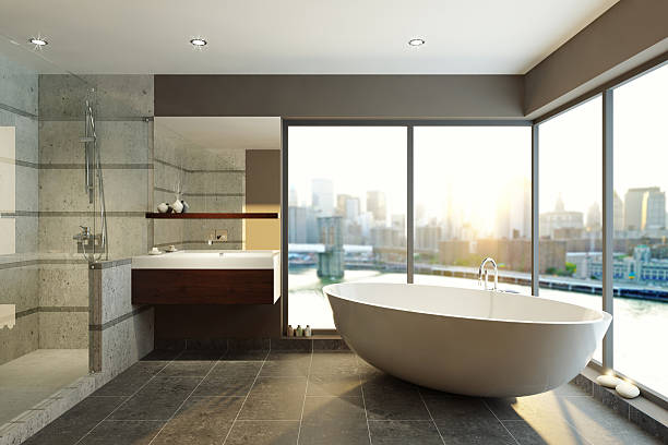Modern bathroom with city skyline views Modern Bathroom with City Skyline free standing bath stock pictures, royalty-free photos & images