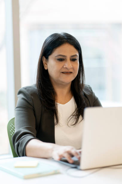 istock Confident Indian businesswoman using laptop computer, typing on keyboard, working online in office 1737228649