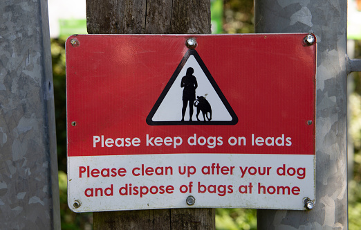 Dogs on lead and clean up after your dog sign