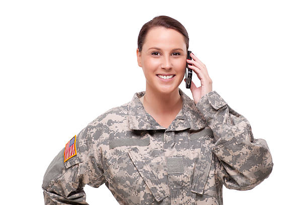 istock Smiling female soldier using mobile phone 173724650