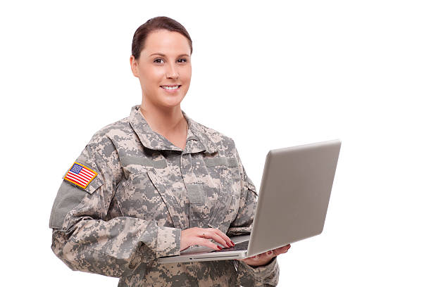 Portrait of a female soldier using laptop stock photo