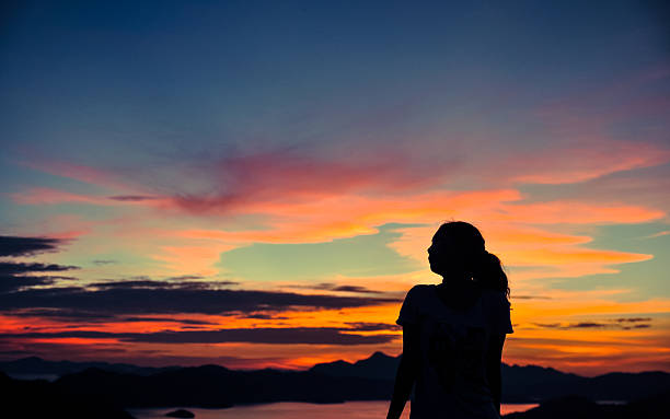istock silhouette of young girl when sunset 173725086