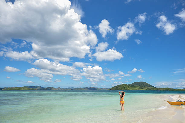 istock young girl stands on white beach 173725141