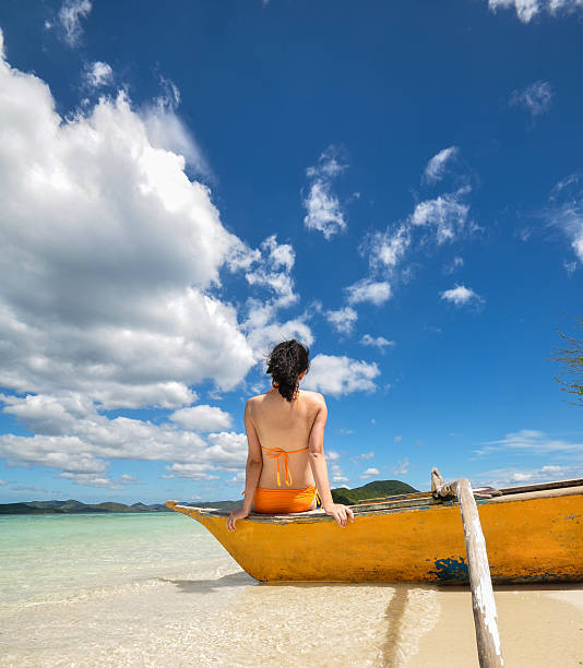 istock young girl sitting on beach boat 173725145