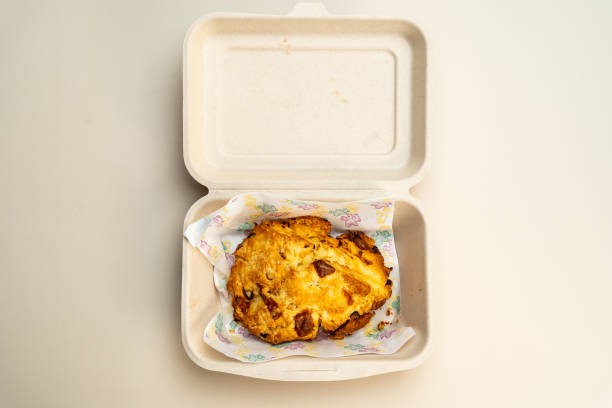 istock Green onion scones in a cardboard box for customers to take home. 1737252120