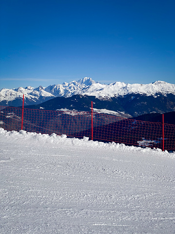 Scenic view of Mont Blanc mountain, France from a ski slope in Meribel with red safety net