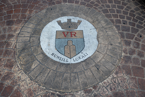 Gozo, Malta, May 3, 2023. Coat of arms formed from cobblestones on the ground of the town of Victoria