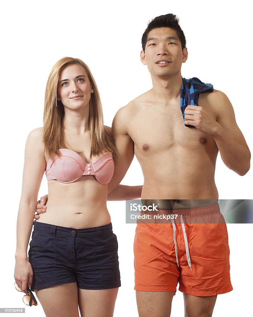 Young Couple in Swimwear Young couple in swimwear. Studio shot over white. 20-29 Years Stock Photo