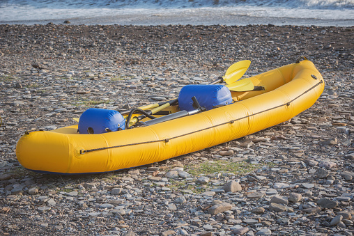 Inflatable boat on the seashore at sunset.