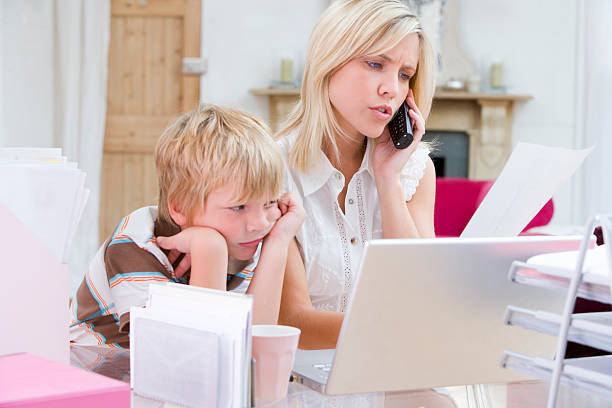 istock Woman using telephone in home office with laptop 173728101