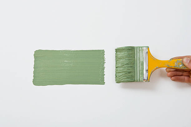 istock Paintbrush painting wall into green 173728179