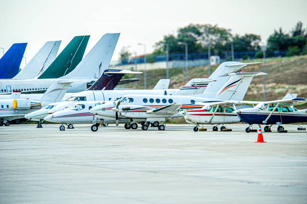 Large passenger planes and small planes waiting at the airport