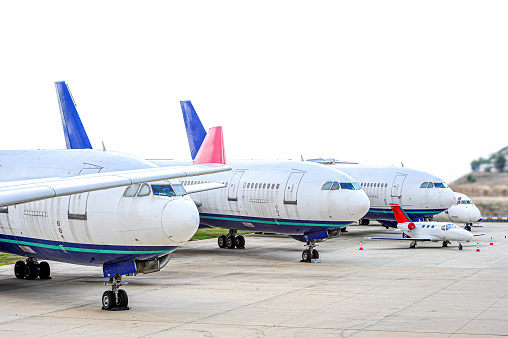 Passenger planes and small private plane waiting at the airport