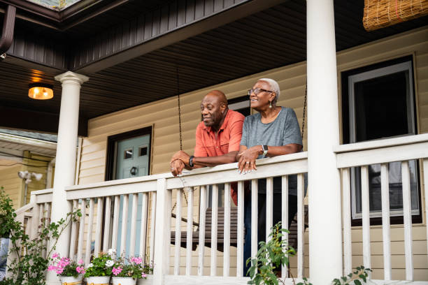 Senior Black couple relaxing on veranda, summer afternoon