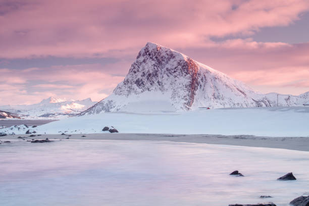 istock Snow capped mountain and reflection on ice with sunset as background in Leknes 1737298235