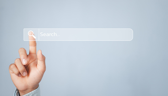 Human hand touching search bar for Search Engine Optimization or SEO to search information or information by internet connection, internet, network, database,information system.