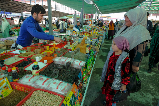 Namangan, Uzbekistan - October 15, 2023: A spice seller at the Chorsu Bazaar in Namangan, Uzbekistan.