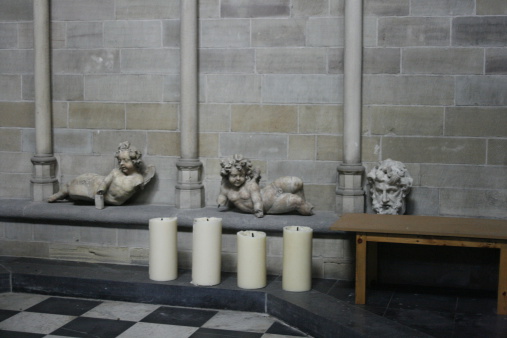 Candles and cherubs and a head - Church in Belgium