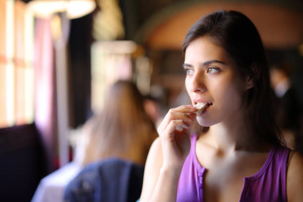 istock Beautiful customer eating bread in a restaurant 1737323453