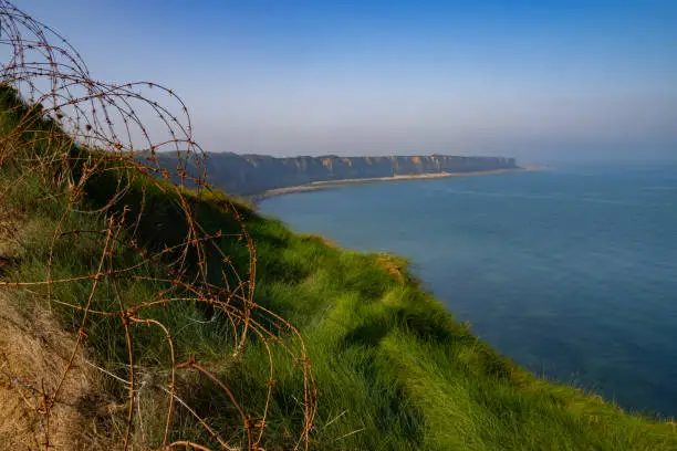 View of the coast of Normandy with barbed wire in the foreground from Pointe du Hoc