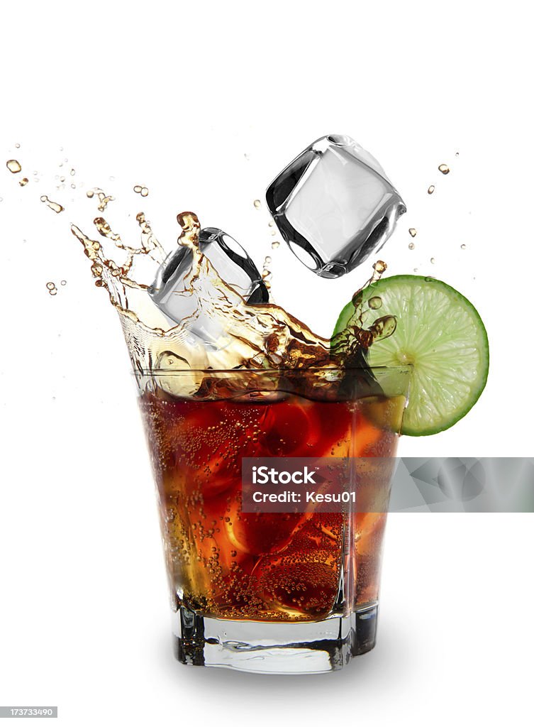 Cola glass with falling ice cubes Cola glass with falling ice cubes over white Alcohol - Drink Stock Photo