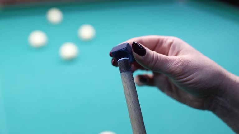 Cue stick with chalk block on blue pool table