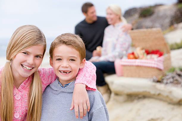 istock Family at beach with picnic smiling 173734075