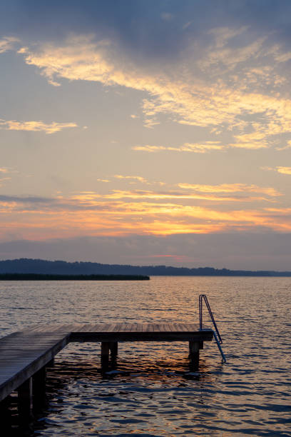 istock Sunrise with jetty at the lake Schaalsee in Seedorf, Germany 1737367253