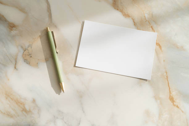 istock Greeting, wedding or congratulations stationery mockup. White blank paper mockup on marble table 1737368447