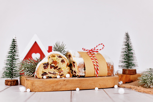 Cut open German Stollen cake, a fruit bread with nuts, spices, and dried fruits with powdered sugar traditionally served during Christmas time