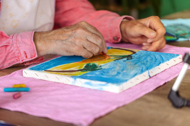 istock Senior Artist Painting on Mini Canvas 1737377689