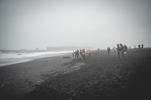 Black Sand Beach Reynisfjara with lots of tourist people in the background, Iceland