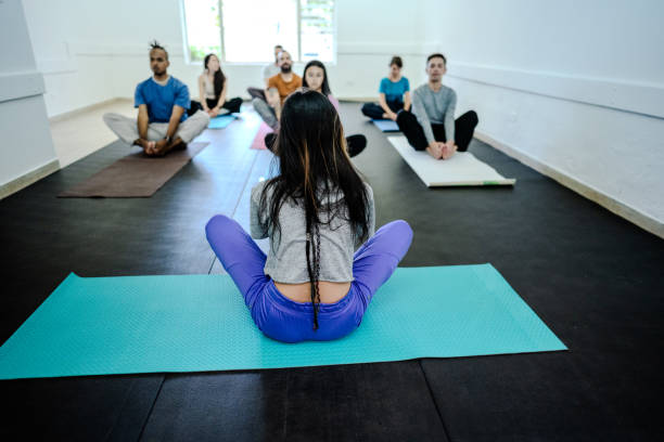 istock Rear view of yoga instructor during yoga class 1737383916