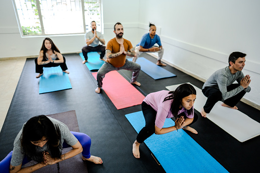 People practicing yoga at yoga studio