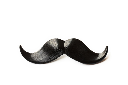 Black curly artificial mustache isolated on white background