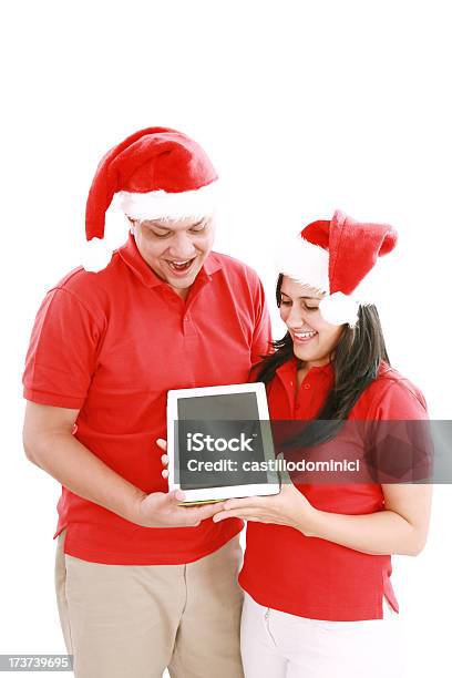 Foto de Casal Apreciando Seu Novo Touchpad No Natal e mais fotos de stock de Acessório - Acessório, Agenda Eletrônica, Boné