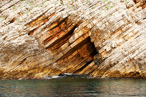 Seascape with a cut cliff edge and a dark sea water. Beautiful nature backgrounds