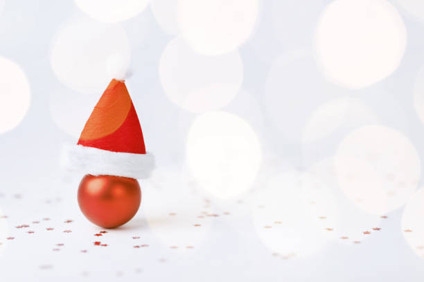 istock Christmas ball with Christmas hat on white background 1737410322