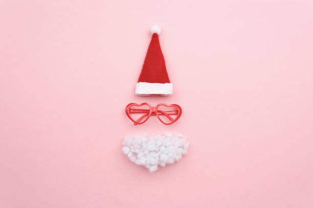 istock Santa hat, beard and glasses on color background top view 1737420488