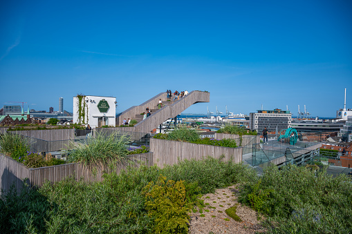 Salling ROOFTOP Roof Garden at Aarhus, Denmark with tourists sitting on a staircase, wide angle shot
