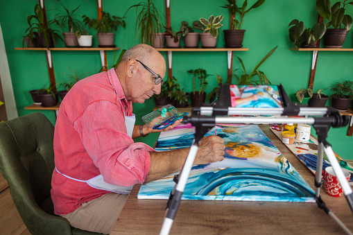 An elderly male artist's passion for both painting and teaching shines through in his online watercolor painting class.