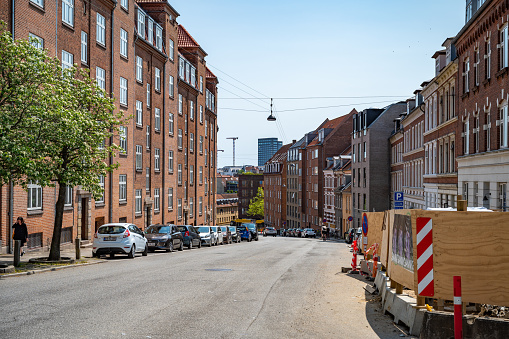 Residential Area in Aarhus with old sandstone buildings, construction area and street in front, Denmark